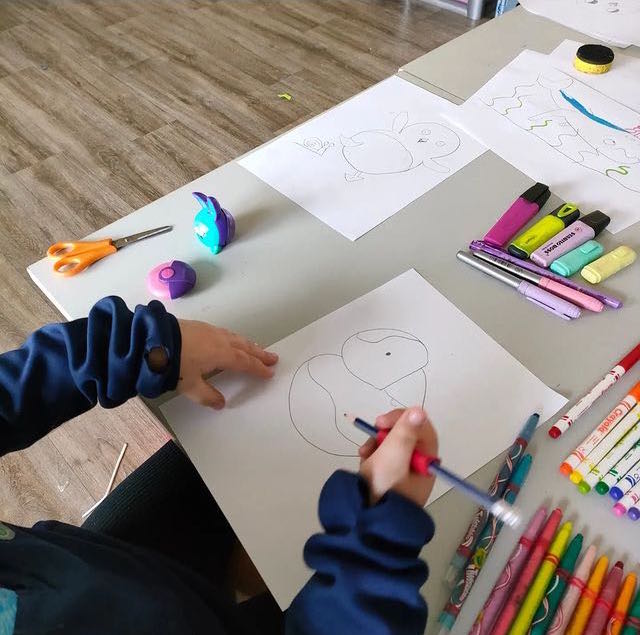 A child drawing a puffin