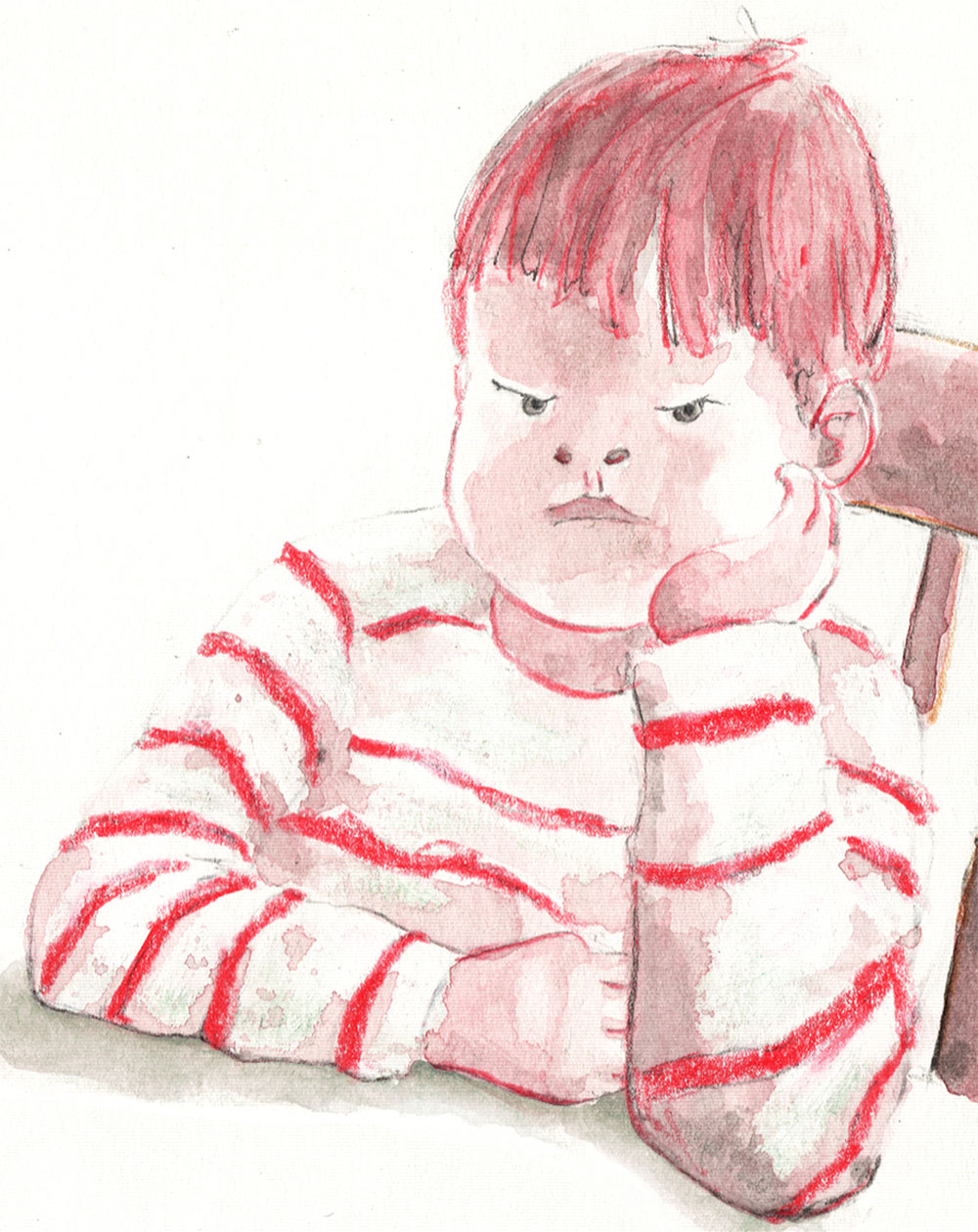 A sulking boy sits at the kitchen table staring at his pushed away dinner plate which has unwanted brocolli on it